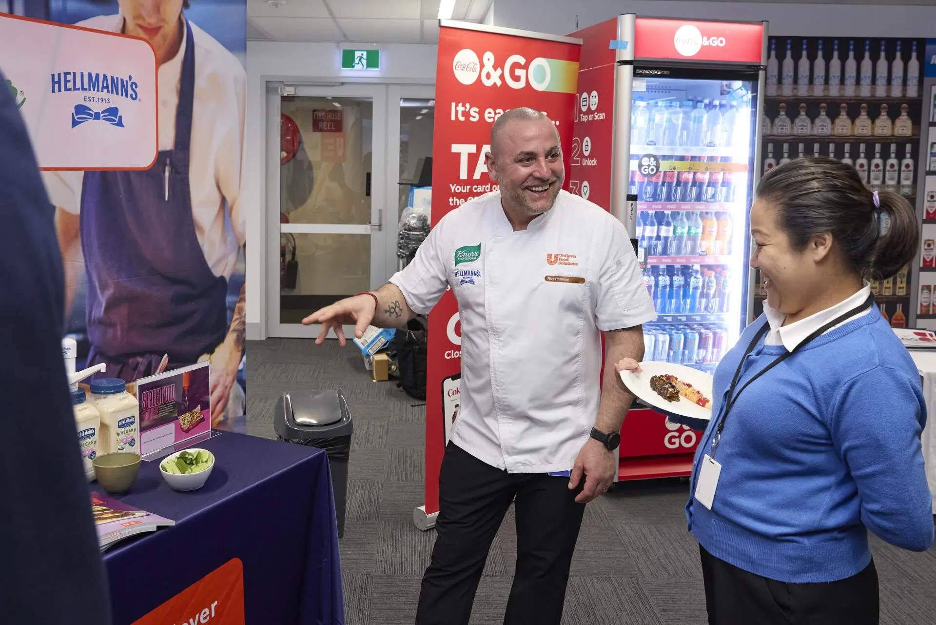 People chat at a supplier pod